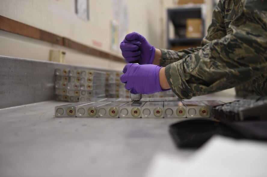 A 62nd Maintenance Squadron conventional maintenance Airman stamps newly built C-17 Globemaster III flares at Joint Base Lewis-McChord, Wash., March 14, 2017. These aircraft-dispensed flares are used as infrared countermeasures designed to defeat heat seeking surface-to-air missiles. (Air Force photo/ Staff Sgt. Naomi Shipley)