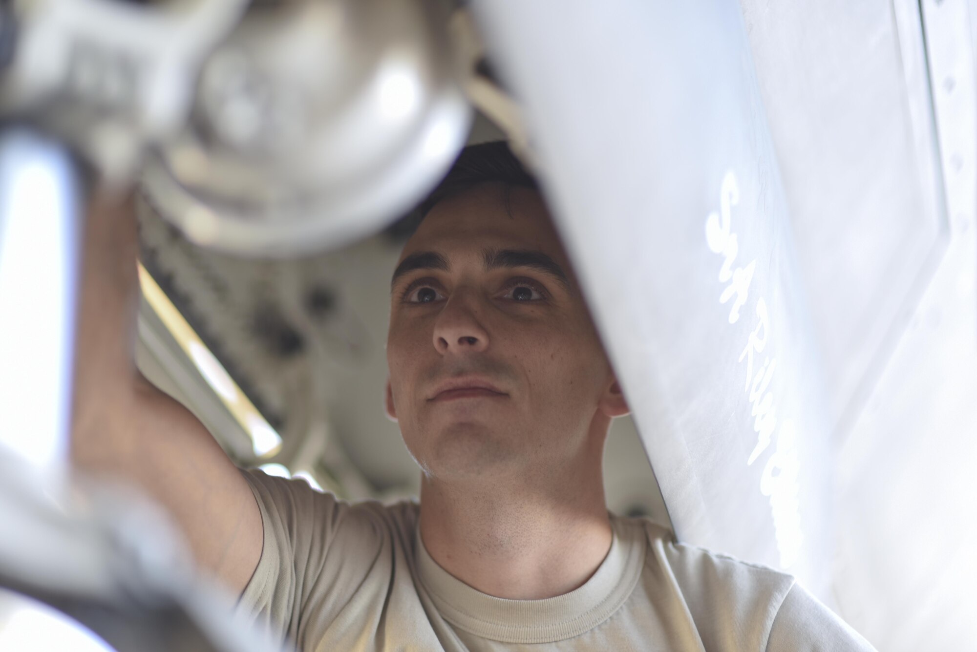 U.S. Air Force Tech. Sgt. Robert Mackle, 325th Aircraft Maintenance Squadron dedicated crew chief, inspects the housing of the front facing light of a F-22 Raptor on the Tyndall Air Force Base, Fla., flightline March 19, 2017. Mackle recently won the Chief Master Sergeant of the Air Force Thomas N. Barnes Crew Chief of the Year Award during the 325th Maintenance Group’s Maintenance Professional of the Year Award ceremony that was hosted Feb. 17, 2017. (U.S. Air Force photo by Senior Airman Solomon Cook/Released) 