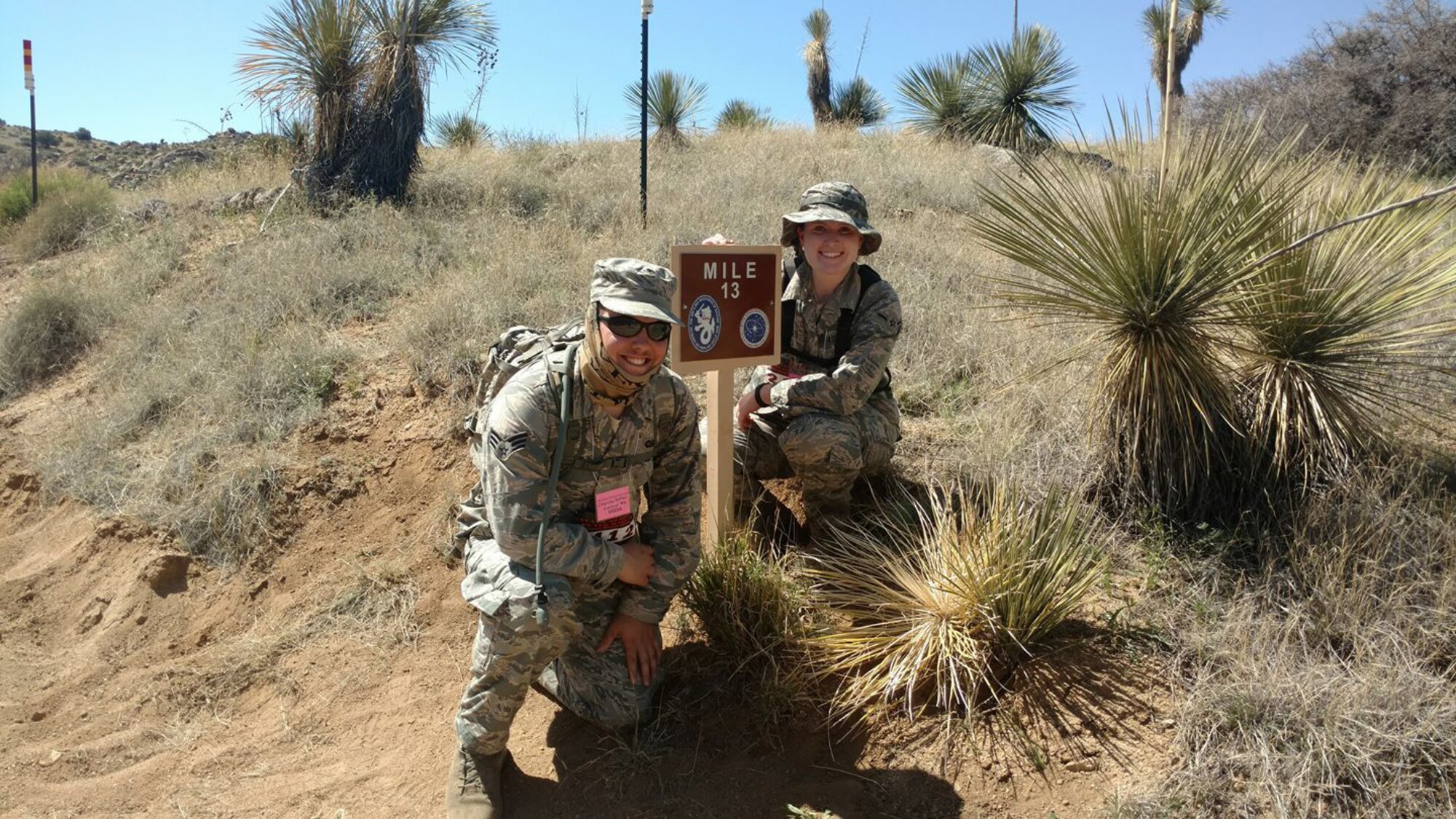 Senior Airman Chandler Baker and Airman Lexi Crawford, 377th Air Base Wing's Public Affairs Office, pause at the halfway mark of the Bataan Memorial Death March to pose for a photo. The two participated in a 26-mile march through the high desert terrain of the White Sands Missile Range, N.M. The memorial march is conducted in honor of the heroic service members who defended the Philippine Islands during World War II, sacrificing their freedom, health, and, in many cases, their very lives. (Courtesy Photo)