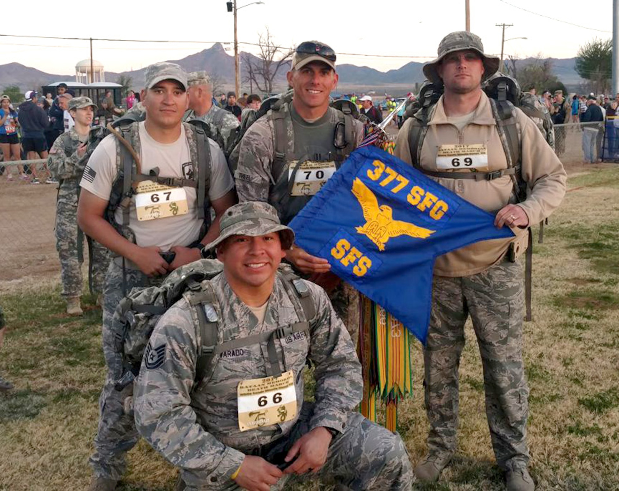 Tech. Sgt. Guillermo Castellano, Staff Sgt. Tanner Theel, Master Sgt. Seth Stockwell and Tech. Sgt. Felipe Alvarado, 377th Security Force Group, get ready to participate in the Bataan Memorial Death March, a 26-mile march through the high desert terrain of the White Sands Missile Range, N.M. The memorial march is conducted in honor of the heroic service members who defended the Philippine Islands during World War II, sacrificing their freedom, health, and, in many cases, their very lives. (U.S. Air Force Photo/Senior Airman Chandler Baker)