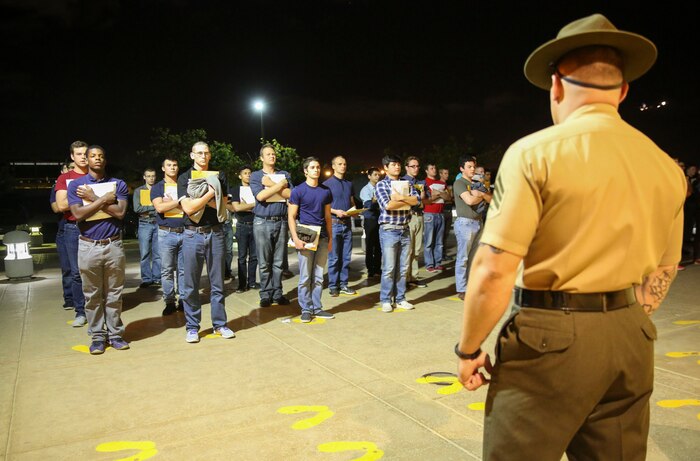 Recruits of India Company, 3rd Recruit Training Battalion, are welcomed to the depot by Sgt. Steven J. Kilpatrick, drill instructor, Receiving Company, as they stand on the yellow footprints during receiving at Marine Corps Recruit Depot San Diego, March 20. From this point on, recruits will eat, sleep and train as a team as they begin the transformation from civilian to Marine. Annually, more than 17,000 males recruited from the Western Recruiting Region are trained at MCRD San Diego. India Company is scheduled to graduate June 16.