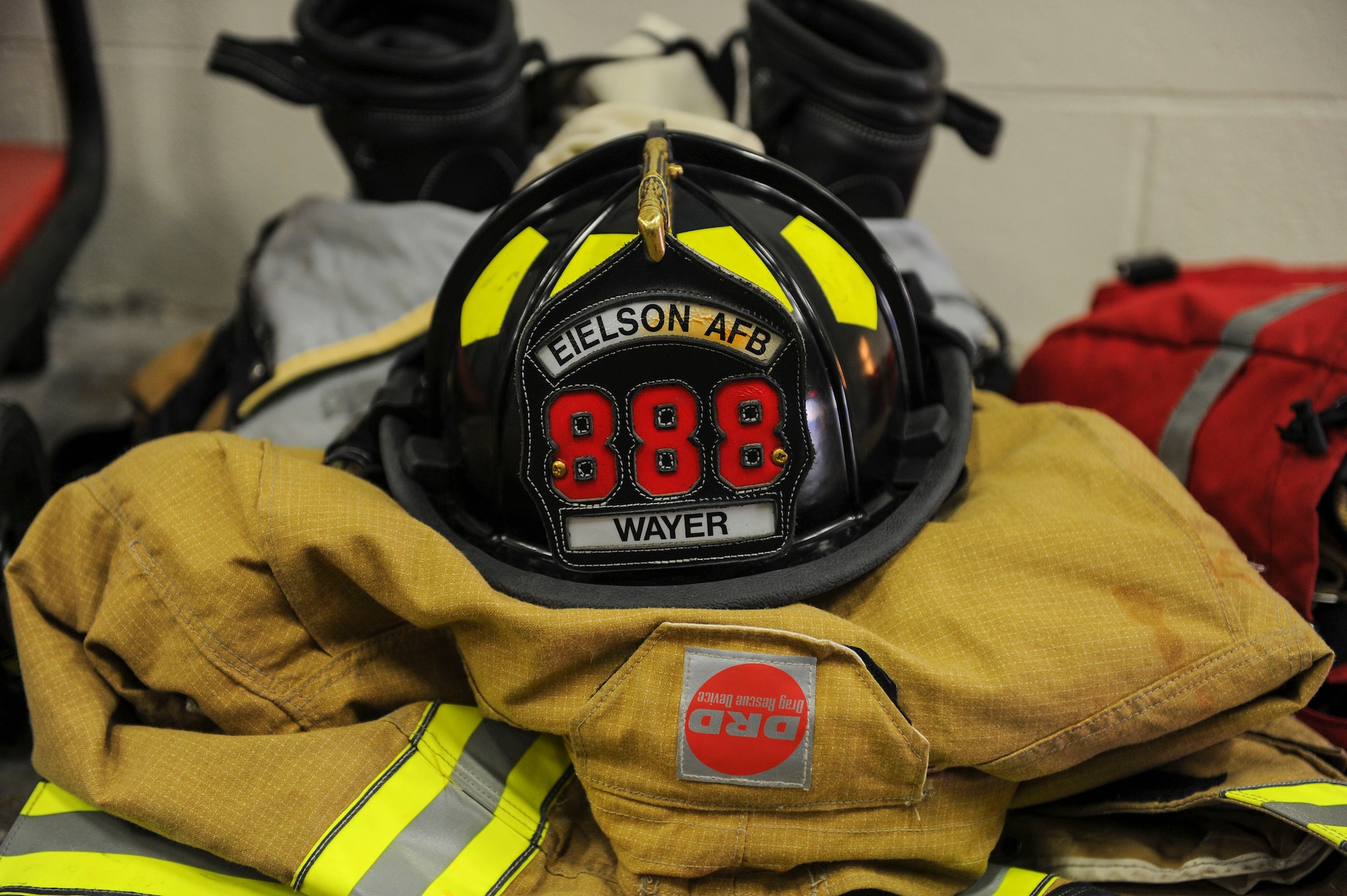 Equipment belonging to a U.S. Air Force firefighter from the 354th Civil Engineer Squadron, rests on the floor March 13, 2017, at Eielson Air Force Base, Alaska. Eielson firefighters support the communities fire and emergency services by lending them manpower and equipment. (U.S. Air Force photo by Airman 1st Class Isaac Johnson)