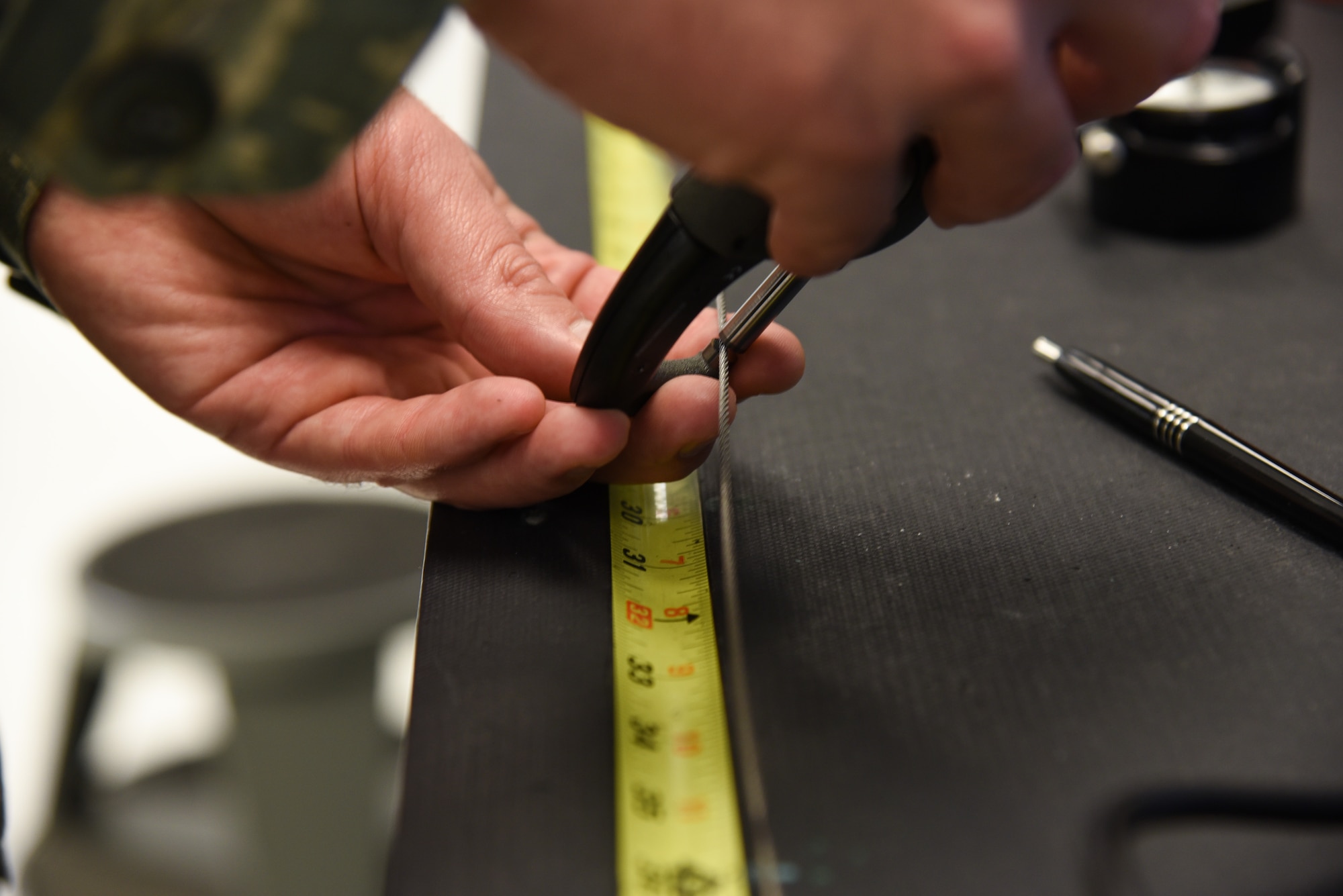 Staff Sgt. Kevin Amrich, 60th Maintenance Squadron precision measurement equipment laboratory technician, measures a cable prior to a test for a cable tensiometer at Travis Air Force Base, Calif., March, 13, 2017. The Travis PMEL shop accomplishes 10,000 maintenance actions per year. (U.S. Air Force photo by Senior Airman Sam Salopek)