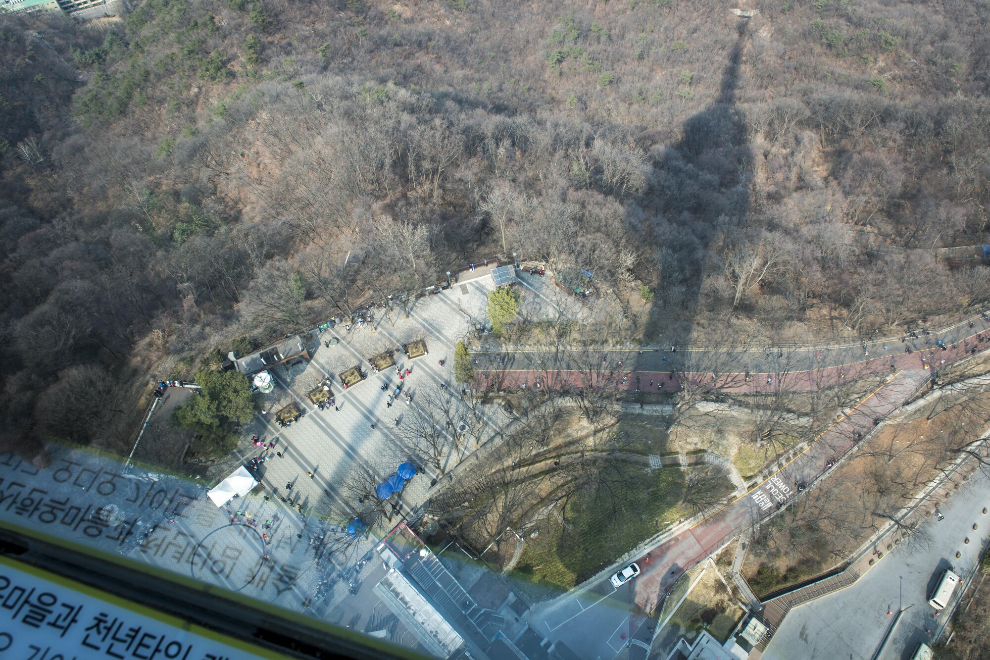 At 1,575 feet above sea level, the Namsan Seoul Tower is the first tower-type tourism spot in Korea with views as far as the eye can see and pictured here its shadow extends well beyond the base into the surrounding park and forest in Seoul, Republic of Korea, March 18, 2017. A group of 60 U.S. service members assigned to Key Resolve 2017 hiked the steep hill hoping to get a glimpse of the ROK’s capital on a first-ever tour to Seoul where they experienced the Korean culture first-hand. The tower is Korea’s first general radio wave tower. It was built to promote the future of broadcasting and the tourism industry. It combines a broadcast tower and an observatory which embodies traditional Korean design. (U.S. Air Force photo by Staff Sgt. Benjamin W. Stratton)