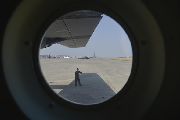 Staff Sgt. Benjamin Baughman, 36th Airlift Squadron loadmaster instructor, wraps ground wire around his arm prior to flight in a C-130J Super Hercules at Yokota Air Base, Japan, March 20, 2017. In case the aircraft is hit by lightning, the ground wire provides a conducting path towards the earth allowing the aircraft not to be effected by the electrical current. (U.S. Air Force photo by Staff Sgt. David Owsianka)