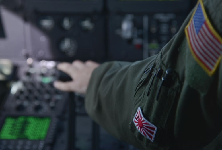 Maj. Jesse Klaetsch, 36th Airlift Squadron pilot, pushes down on the throttle while flying the first Yokota C-130J Super Hercules training sortie over the skies of Japan March 20, 2017. Compared to older C-130s, the J model climbs faster and higher, flies farther at a higher cruise speed, and takes off and lands in a shorter distance. (U.S. Air Force photo by Staff Sgt. David Owsianka)