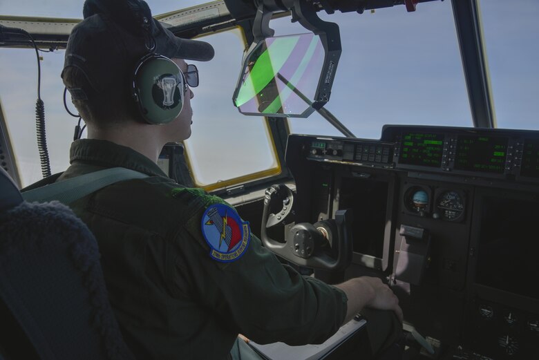 Capt. Chase Hessman, 36th Airlift Squadron pilot, looks at the heads up display during the first Yokota C-130J Super Hercules training sortie over the skies of Japan March 20, 2017. The display allows the pilots to view information such as altitude and airspeed while continuing to focus on flying. (U.S. Air Force photo by Staff Sgt. David Owsianka)