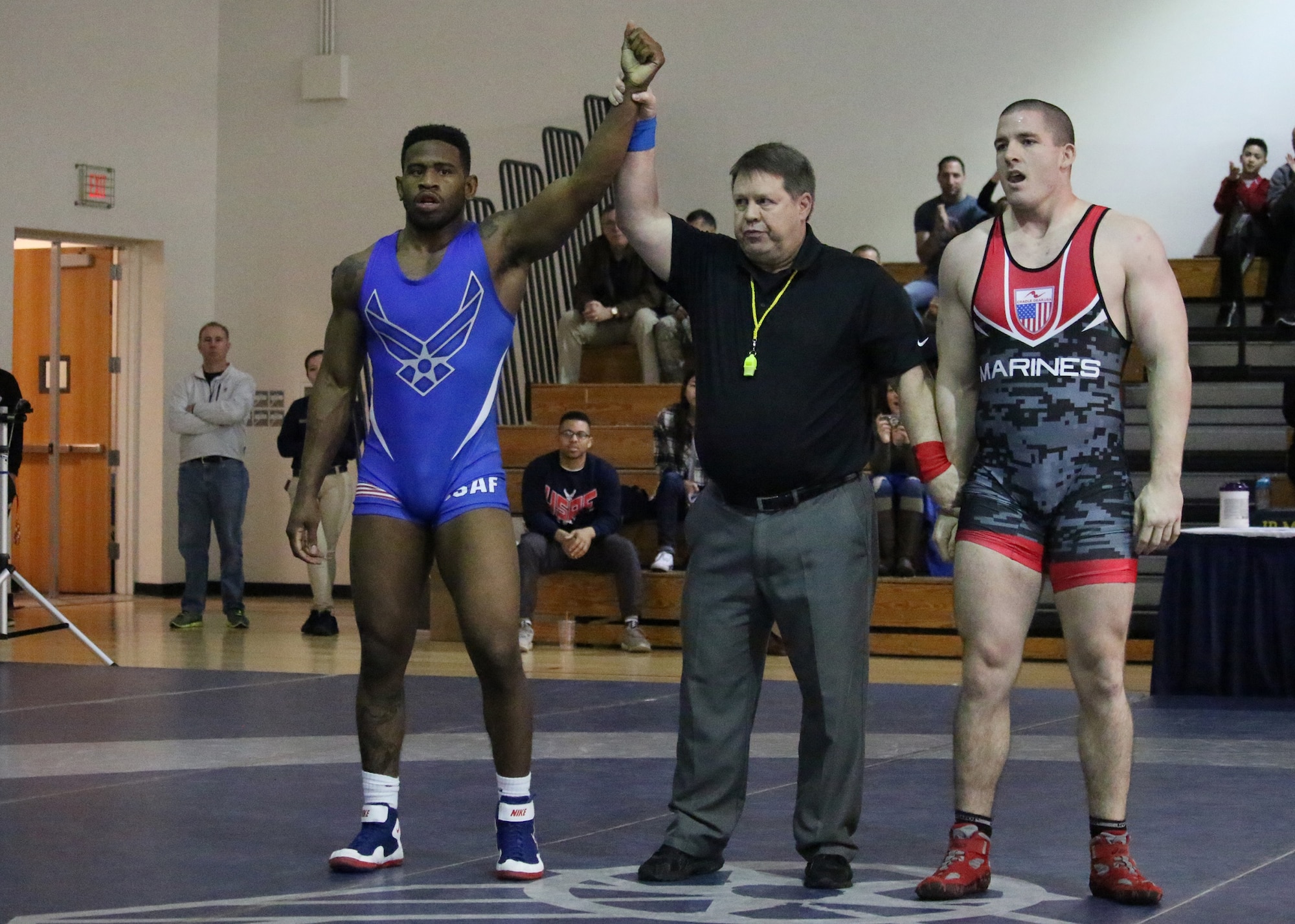 Senior Airman Brandon Johnson is declared the victor in a match with Marine Michael Brant at the 2017 Armed Forces Championship Febuary 26, 2017, at Joint Base McGuire-Dix-Lakehurst, NJ. (U.S Air Force courtesy photo)