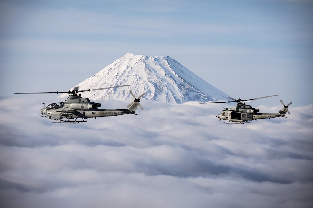 Two Marine Corps helicopters, an AH-1Z Viper and UH-1Y Venom, fly past Mount Fuji, Shizuoka, Japan, March 12, 2017. The helicopters are assigned to Marine Light Attack Helicopter Squadron 267, which is supporting Marine Aircraft Group 36, 1st Marine Aircraft Wing and 3rd Marine Expeditionary Force. The Marines validated the long-range capability of auxiliary fuel tanks on their H-1 platform helicopters by flying 314 nautical miles during one leg of the four-day mission. The  extended range is crucial to maintaining a stronger, more capable forward-deployed force in the Indo-Asia-Pacific region.  Marine Corps photo by Lance Cpl. Andy Martinez