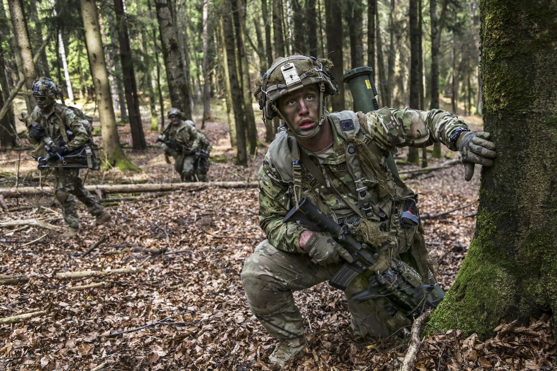 A soldier pauses by a tree during a maneuver as part of Allied Spirit VI at 7th Army Training Command’s Hohenfels Training Area, Germany, March 17, 2017. The exercise, which includes about 2,770 participants from 12 NATO and partner nations, tests secure communications within alliance members. Army photo by Sgt. Seth Plagenza