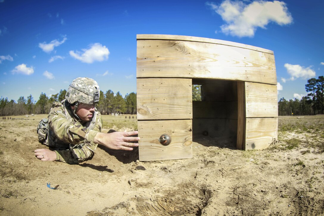 A soldier tosses a simulated M67 fragmentation hand grenade into a bunker during a training event at Fort Bragg, N.C., March 19, 2017. The soldier is assigned to the 122nd Aviation Support Battalion. Army photo by Sgt. Steven Galimore