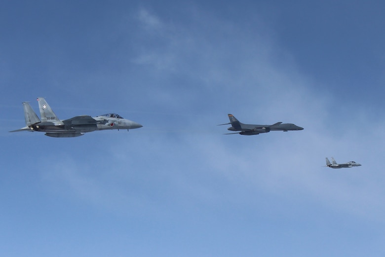 A U.S. Air Force B-1B Lancer flies in formation with Japan Air Self Defense Force F-15s in the vicinity of Japan March 21, 2017. The sortie was carried out as part of U.S. Pacific Command's continuous bomber presence mission.