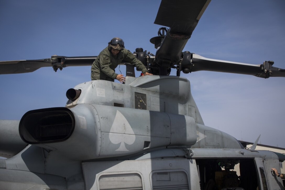 Sgt. Kevin Carpio, a UH-1Y Venom crew chief with Marine Light Attack Helicopter Squadron 267, currently assigned to Marine Aircraft Group 36, 1st Marine Aircraft Wing, III Marine Expeditionary Force through the unit deployment program, inspects helicopter propellers at Marine Corps Air Station Iwakuni, Japan, March 12, 2017. The squadron, based out of Camp Pendleton, California, validated the long-range capability of the auxiliary fuel tanks on their H-1 platform helicopters by flying 314 nautical miles during one leg of the journey, March 10. These aircrafts’ extended range is crucial to maintaining a stronger, more capable forward-deployed force in the Asia-Pacific region. Carpio is a native of Bronx, New York. (U.S. Marine Corps photo by Lance Cpl. Andy Martinez) 