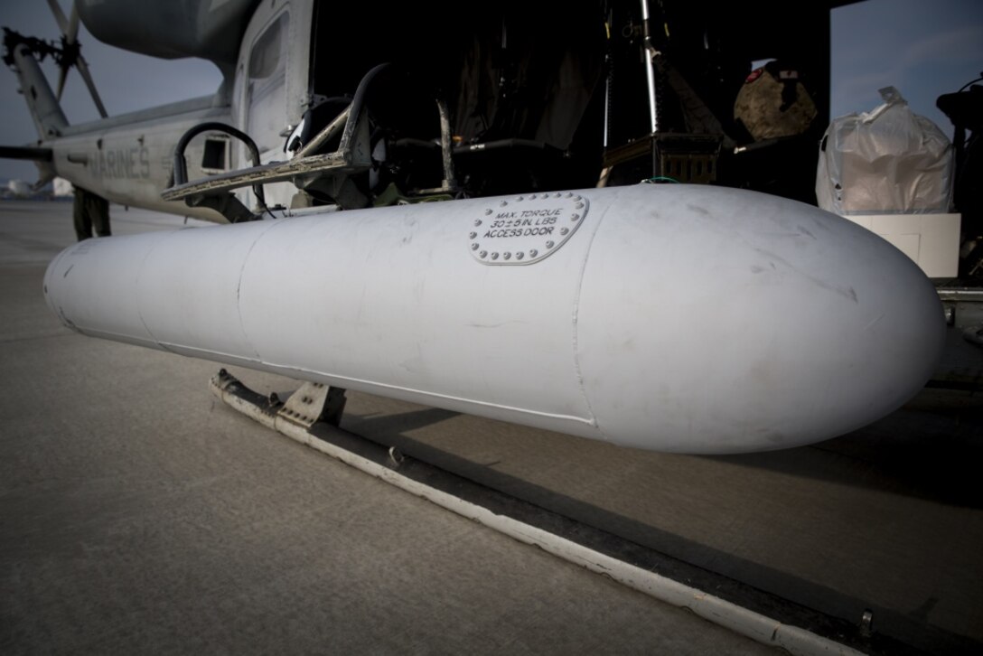 New auxiliary fuel tanks, like the one pictured, help AH-1Z Viper and UH-1Y Venom helicopters increase their range by more than 25%. Marine Light Attack Helicopter Squadron 267 validated the long-range capability of the auxiliary fuel tanks on their H-1 platform helicopters by flying more than 300 nautical miles during one leg of a four-day mission. These aircrafts’ extended range is crucial to maintaining a stronger, more capable forward-deployed force in the Indo-Asia-Pacific region. The Marines in HMLA-267, based out of Camp Pendleton, California, are currently supporting Marine Aircraft Group 36, 1st Marine Aircraft Wing, III Marine Expeditionary Force through the unit deployment program. (U.S. Marine Corps photo by Lance Cpl. Andy Martinez) 