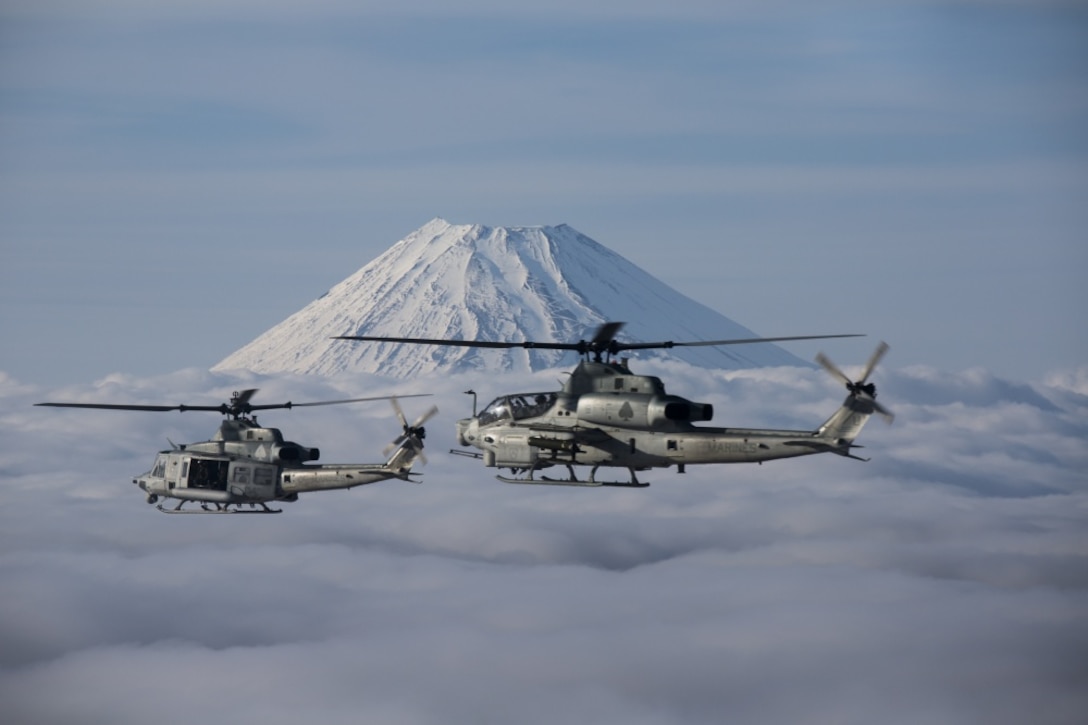 A UH-1Y Venom leads the way for an AH-1Z Viper flying by Mount Fuji, Shizuoka, Japan, March 12, 2017. Marine Light Attack Helicopter Squadron 267 validated the long-range capability of the auxiliary fuel tanks on their H-1 platform helicopters by flying more than 314 nautical miles during one leg of the four-day operation, March 10. These aircrafts’ extended range is crucial to maintaining a stronger, more capable forward-deployed force in the Indo-Asia-Pacific region. The Marines in the aircraft are with HMLA-267, currently assigned to Marine Aircraft Group 36, 1st Marine Aircraft Wing, III Marine Expeditionary Force through the unit deployment program. The squadron is based out of Camp Pendleton, California. (U.S. Marine Corps photo by Lance Cpl. Andy Martinez)