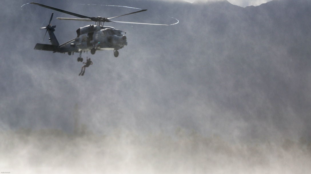 A search and rescue swimmer with Helicopter Maritime Strike Squadron 37 is lowered from a MH-60R helicopter during a search and rescue exercise off the shores of Marine Corps Base Hawaii on March 15, 2017. The Sailors conducted the exercise to better prepare for future deployments. 