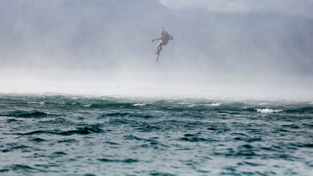 A search and rescue swimmer with Helicopter Maritime Strike Squadron 37 is lowered from a MH-60R helicopter during a search and rescue exercise off the shores of Marine Corps Base Hawaii on March 15, 2017. The Sailors conducted the exercise to better prepare for future deployments. 