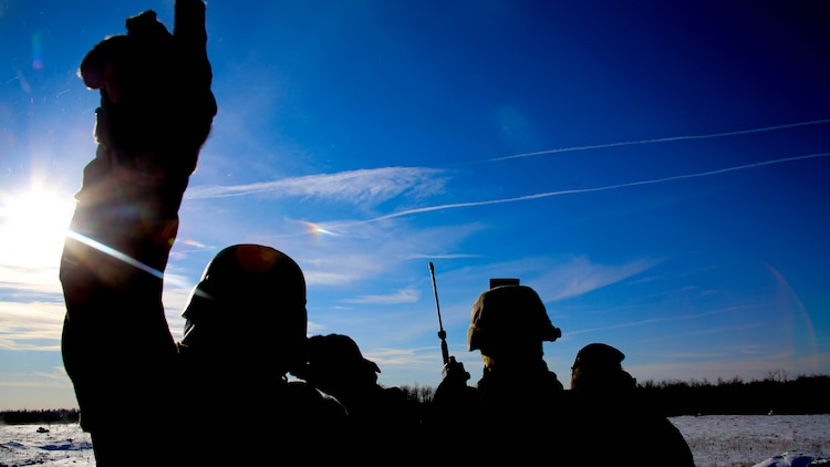 Staff Sgt. Randall Lester (left) points toward aircraft as Maj. Lauchlin Byrd (center) and Maj. Thomas Short (right) scan the skies during close air support operations at a range near Fort Drum, N.Y., March 16, 2017. Marines assigned to 1st Air Naval Gunfire Liaison Company, I Marine Expeditionary Force Headquarters Group, I Marine Expeditionary Force, worked in conjunction with Marines assigned to Marine Light Attack Helicopter Squadron 269, Marine Aircraft Group 29, 2nd Marine Aircraft Wing, to complete the training. 