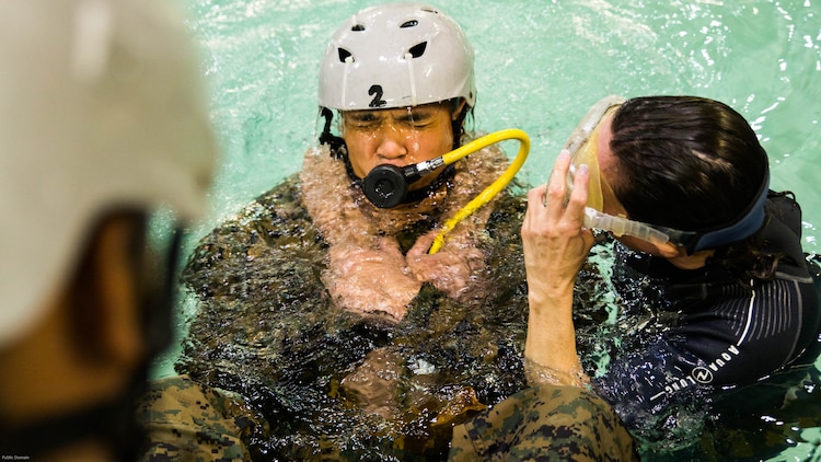 Staff Sgt. Kiriden Benny, the cyber network systems chief with Special Purpose Marine Air-Ground Task Force - Southern Command, practices breathing compressed air during Underwater Egress Training at the Water Survival Training Facility on Marine Corps Base Camp Lejeune, North Carolina, March 8, 2017. The purpose of the training is to teach Marines lifesaving skills in the event of an aircraft mishap in the water. 