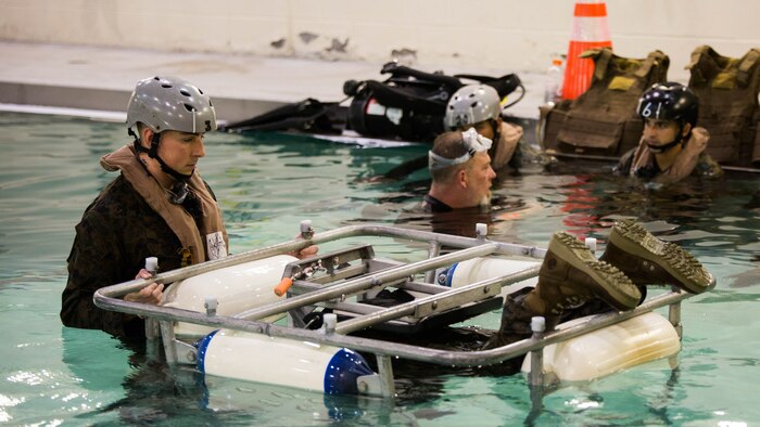 Marines with Special Purpose Marine Air-Ground Task Force - Southern Command use a Shallow Water Egress Trainer to gain confidence in the water during Underwater Egress Training at the Water Survival Training Facility on Marine Corps Base Camp Lejeune, North Carolina, March 8, 2017. The purpose of the training is to teach Marines lifesaving skills in the event of an aircraft mishap in the water. 