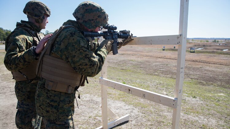 Petty Officer 3rd Class Paul S. Buonfiglio, a hospital corpsman with Special Purpose Marine Air-Ground Task Force - Southern Command, sights in on his target at a Table 3 unknown distance range during pre-deployment training at Range K-501 on Marine Corps Base Camp Lejeune, North Carolina, March 16, 2017. The training was conducted to enhance the Ground Combat Element’s readiness for future security cooperation operations in Central America. 