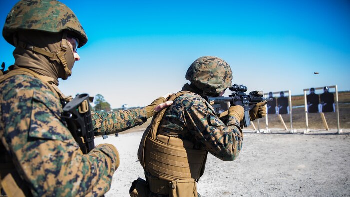 Cpl. Steven Dejong, a field radio operator with Special Purpose Marine Air-Ground Task Force - Southern Command, guides Sgt. Travis Nichols, a cyber network operator with SPMAGT-SC, in a movement to contact drill on a Table 5 short distance range during pre-deployment training at Range K-501A on Marine Corps Base Camp Lejeune, North Carolina, March 16, 2017. The training was conducted to enhance the Ground Combat Element’s readiness for future security cooperation operations in Central America. 