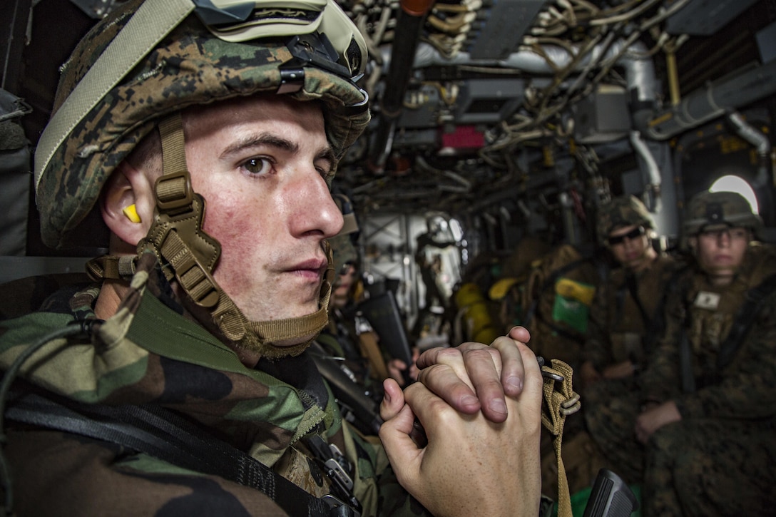 U.S. Marine Corps Staff Sgt. Dylan Worrell looks out from an MV-22 Osprey over Okinawa, Japan, March 21, 2017. Worrell is the incident commander for the 3rd Marine Division's Chemical, Biological, Radiological and Nuclear Platoon. Marine Corps photo by Lance Cpl. Jesus McCloud