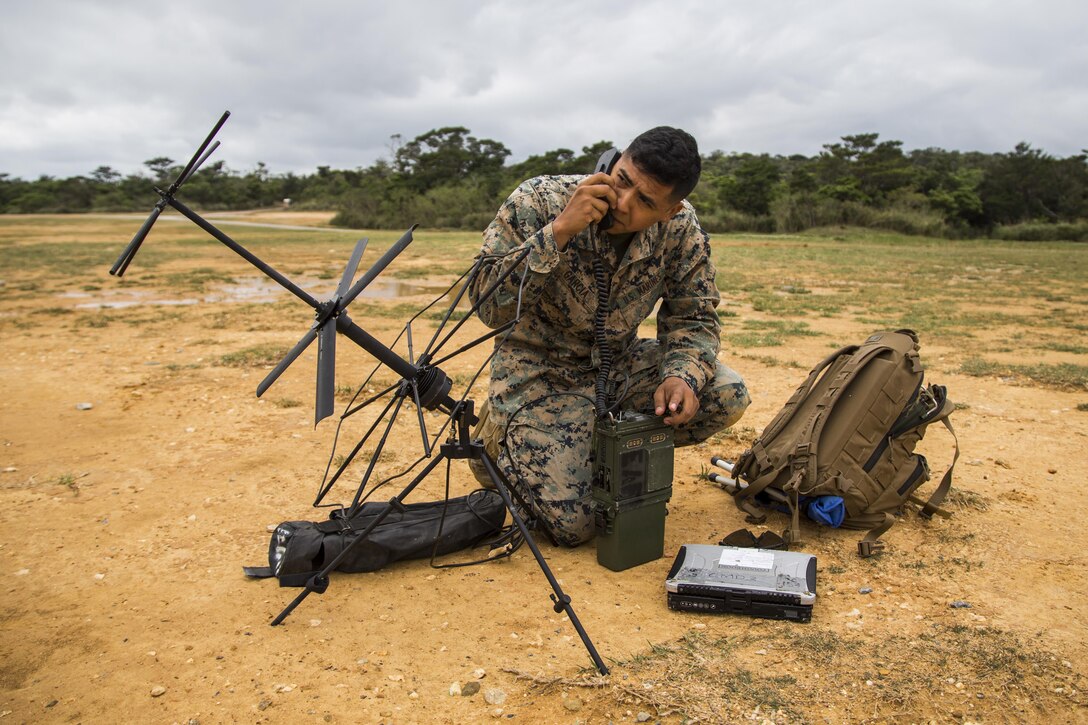 Marine Corps Lance Cpl. Elias Garcia, embedded with the 3rd Marine Division's Chemical, Biological, Radiological and Nuclear Platoon, establishes communication after arriving at Landing Zone Dodo, Camp Hansen, Okinawa, Japan, March 21, 2017. Marine Corps photo by Lance Cpl. Jesus McCloud