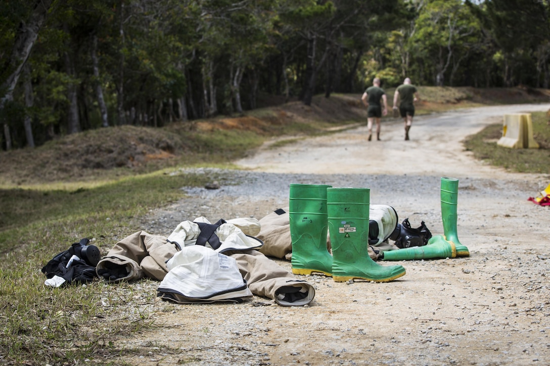 U.S. Marine Corps Cpl. James Dietrich, right, and Lance Cpl. Nickolas Giffen head toward the “cold zone” after going through the decontamination line on Combat Town, Okinawa, Japan, March 21, 2017. Dietrich is the ampling team leader and Giffen is a sampling team member with the 3rd Marine Division's Chemical, Biological, Radiological and Nuclear Platoon. Marine Corps photo by Lance Cpl. Jesus McCloud