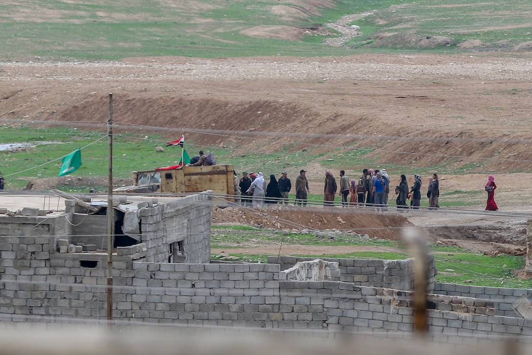 Citizens evacuate the western edge of Mosul during the offensive by the 9th Iraqi Army Division, supported by Combined Joint Task Force-Operation Inherent Resolve, to liberate the city  from ISIS, March 19, 2017. CJTF-OIR is the global Coalition to defeat ISIS in Iraq and Syria. (U.S. Army photo by Staff Sgt. Jason Hull)