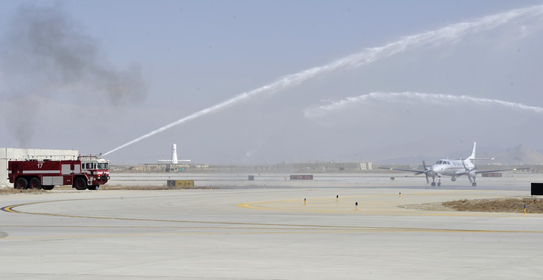 BAGRAM AIRFIELD, Afghanistan (Mar. 17, 2017) - Water plumes greet and honor the final flight of Chief Warrant Officer 4 Joshua Wade Martin as he taxis his C-26 Metroliner to the ramp.  Martin is a 28-year Arkansas Army National Guard veteran who will redeploy soon and retire from military service this summer.  The water salute is an aviation tradition to celebrate a momentous occasion in aviation history.  Photo by Bob Harrison, U.S. Forces Afghanistan Public Affairs.