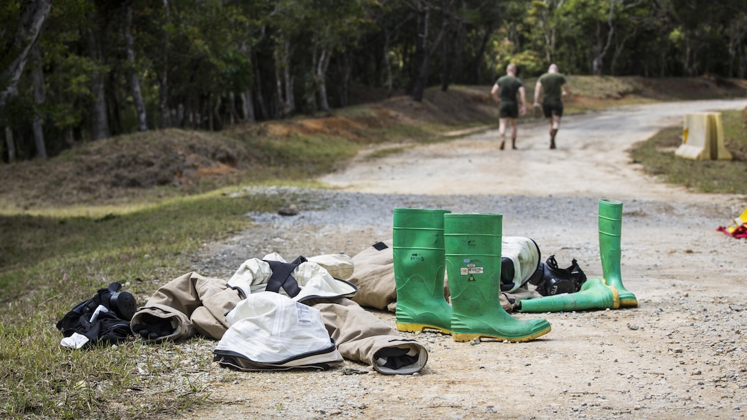 U.S. Marine Corps Cpl. James Dietrich, Sampling Team leader, right, and Lance Cpl. Nickolas Giffen, Sampling Team Member, with Chemical, Biological, Radiological and Nuclear Platoon, G-3, 3d Marine Division, head toward the “cold zone” after going through the decontamination line on Combat Town, Okinawa, Japan, March 21, 2017. The CBRN Platoon conducts response drills to enhance the commander’s capabilities by exercising the operability and efficiency of the consequence management set within the 3d Marine Division CBRN response element.