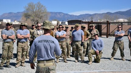Major Brian Carey, 351st Battlefield Airman Training Squadron's director of operations, delivers a safety brief to assault course participants March 16 at Kirtland Air Force Base. Carey provided safety briefs for all obstacles, including some demonstrations. The course includes challenges like low crawls, rope and rock climbing, and jumping over a high wall, and will be used in training BATS students. (U.S. Air Force Photo/Senior Airman Chandler Baker)