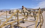 Pararescue trainees from the 351st Battlefield Airmen Training Squadron test the unit's new assault course March 17 at Kirtland. The course includes challenges like low crawls, rope and rock climbing, and jumping over a high wall, and will be used in training BATS students. (U.S. Air Force Photo/Senior Airman Chandler Baker)