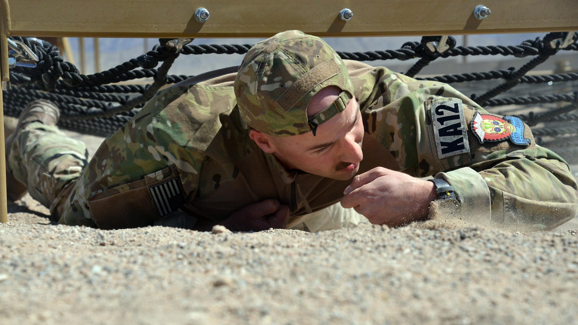 A pararescue trainees from the 351st Battlefield Airmen Training Squadron competes in the unit's new assault course March 17 at Kirtland. The course includes challenges like low crawls, rope and rock climbing, and jumping over a high wall, and will be used in training BATS students. (U.S. Air Force Photo/Senior Airman Chandler Baker)