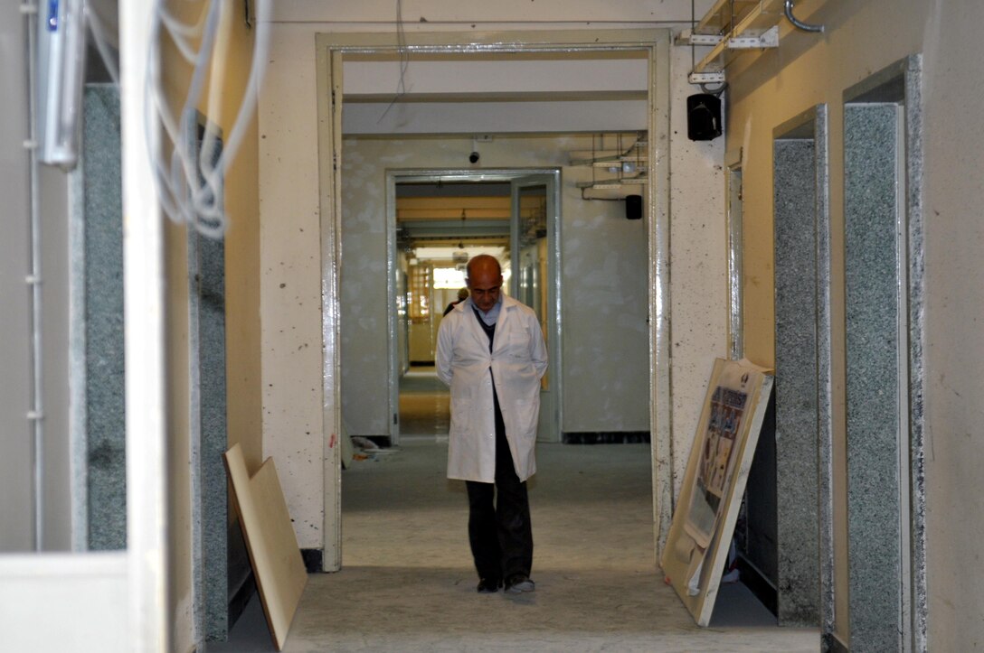 KABUL, Afghanistan (March 8, 2017) — A doctor walks the corridors of Kabul National Military Hospital as the facility undergoes repairs and improvements. The KNMH is primed to emerge from a recent tragic attack as a state-of-the-art facility for patient care, continuing a long legacy as the biggest and finest military hospital in service of the Afghan National Defense and Security Forces.

“No matter what happens and how we are tested, we stand next to our soldiers. This is our chance to improve this hospital and to deliver unprecedented capabilities for medical care. We are focused and determined. Our response is one, to take action,” said Dr. Hamid Rahman, director of the Construction Property Management Department at the Afghan Ministry of Defense. “We have high morale. Our soldiers have high morale. This is a better and stronger us.”

On March 8, a group of terrorist gunmen disguised as doctors attacked the hospital, killing at least 49 patients, doctors and guards, and injuring more than 60 others. The attack on defenseless patients and medical personnel was widely condemned by Afghan leaders and throughout the international community. (U.S. Navy photo by Lt. j.g. Egdanis Torres Sierra, Combined Security Transition Command CSTC–A Public Affairs)