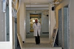 KABUL, Afghanistan (March 8, 2017) — A doctor walks the corridors of Kabul National Military Hospital as the facility undergoes repairs and improvements. The KNMH is primed to emerge from a recent tragic attack as a state-of-the-art facility for patient care, continuing a long legacy as the biggest and finest military hospital in service of the Afghan National Defense and Security Forces.

“No matter what happens and how we are tested, we stand next to our soldiers. This is our chance to improve this hospital and to deliver unprecedented capabilities for medical care. We are focused and determined. Our response is one, to take action,” said Dr. Hamid Rahman, director of the Construction Property Management Department at the Afghan Ministry of Defense. “We have high morale. Our soldiers have high morale. This is a better and stronger us.”

On March 8, a group of terrorist gunmen disguised as doctors attacked the hospital, killing at least 49 patients, doctors and guards, and injuring more than 60 others. The attack on defenseless patients and medical personnel was widely condemned by Afghan leaders and throughout the international community. (U.S. Navy photo by Lt. j.g. Egdanis Torres Sierra, Combined Security Transition Command CSTC–A Public Affairs)