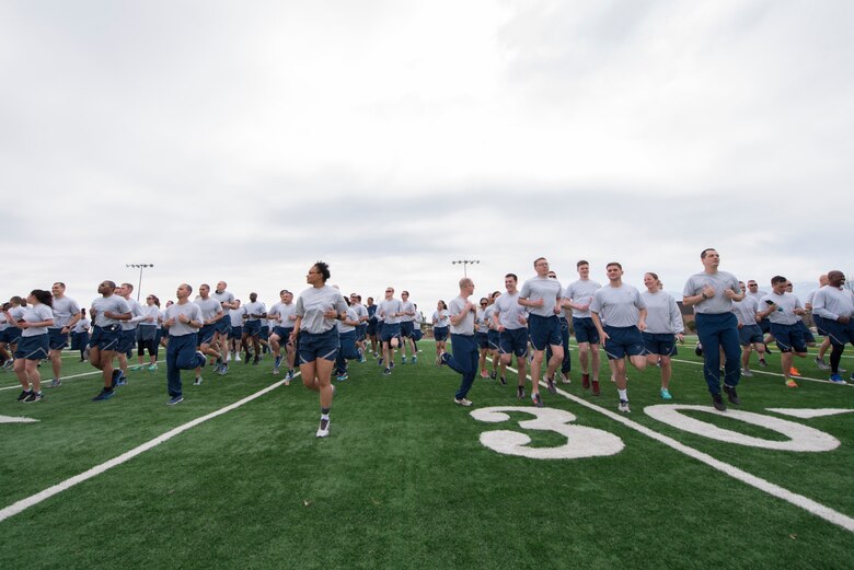 PETERSON AIR FORCE BASE, Colo. – Members of the 21st Space Wing stretch before Wing War Fit at Peterson Air Force Base, Colorado, March 21, 2017. Team Pete had the pleasure of hosting Blue Steel, the commercial, popular music ensemble of the United States Air Force Academy Band. (U.S. Air Force photo by Airman 1st Class Dennis Hoffman)