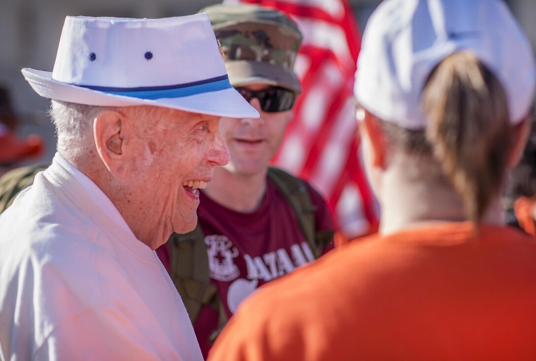 Retired Army Col. Ben Skardon, left, laughs with service members and supporters during the Bataan Memorial Death March at White Sands Missile Range, N.M., March 19, 2017. Skardon is a survivor of the Bataan Death March and is the only survivor who walks in the memorial march. This is the tenth year in a row he has done so. Army photo by Staff Sgt. Ken Scar