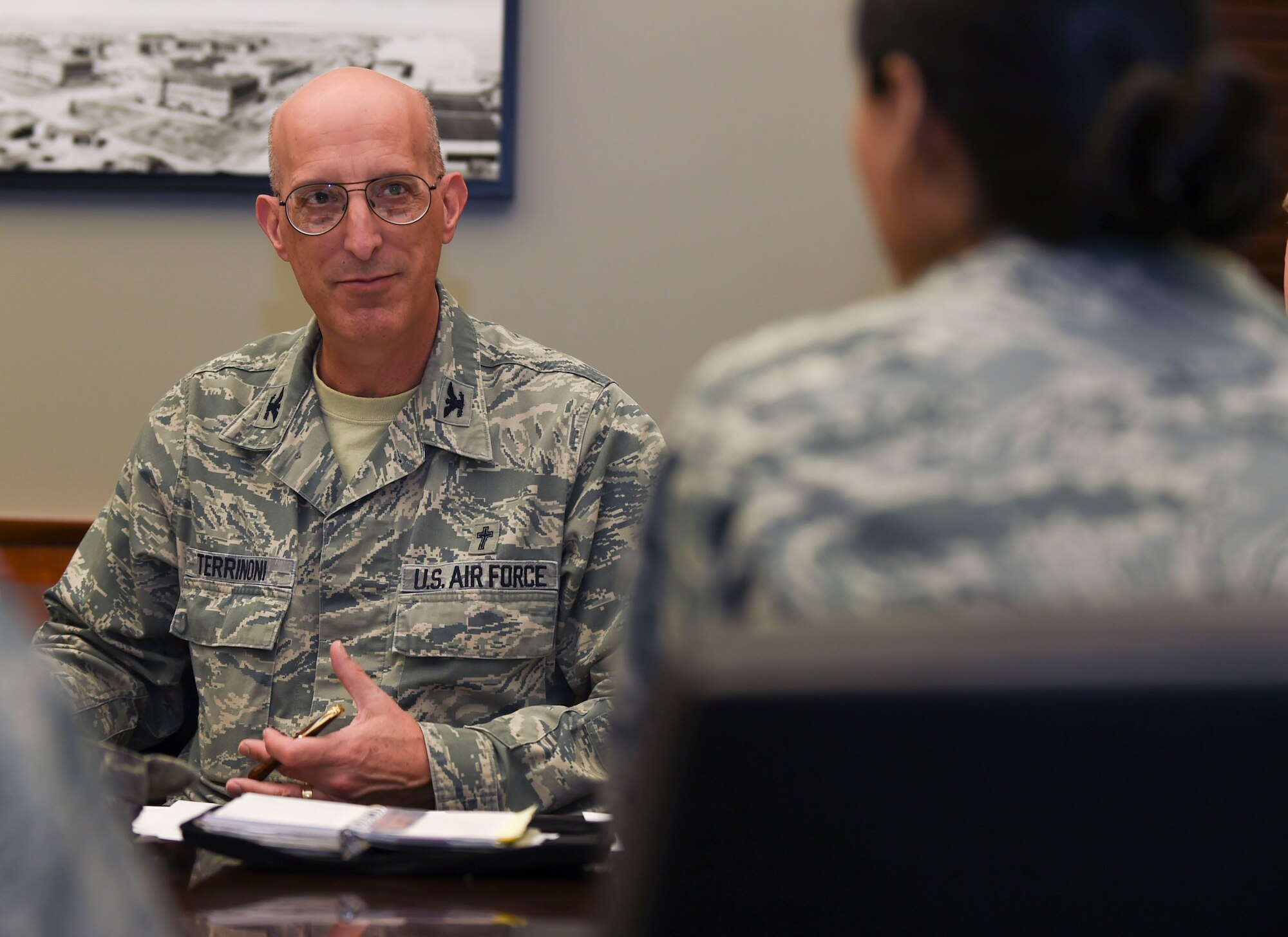 U.S. Air Force Col. David Terrinoni, Joint Base Langley-Eustis senior chaplain, speaks with fellow Integrated Delivery System members regarding action plans they will deliver to senior leaders at Joint Base Langley-Eustis, Va., March 9, 2017. The actions plans are discussed during the quarterly Community Action Information Board, where commanders meet to put the proposed improvements into action. (U.S. Air Force photo/Staff Sgt. Natasha Stannard)