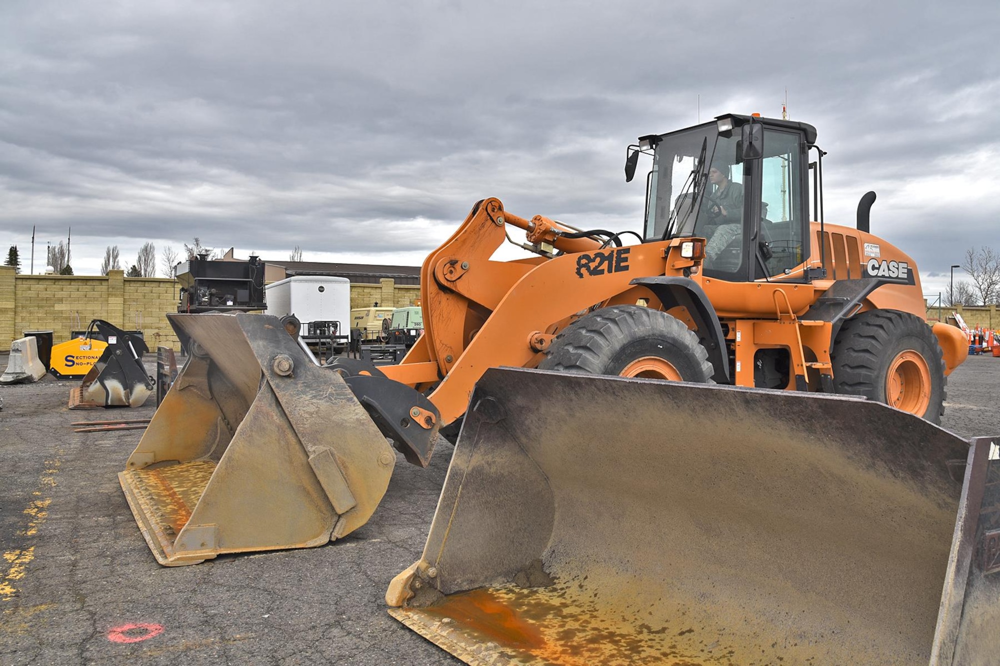 Airman 1st Class Manuel Rivera Matos, 92nd Civil Engineer Squadron pavement and construction journeyman, prepares the loader by switching out attachments Mar. 15, 2017, at Fairchild Air Force Base, Washington. The 92nd CES pavement and construction Airmen and civilians, often referred to as “Dirt Boyz,” were recently named the winners of the American Association of Airport Executives’ Balchen/Post Award for their outstanding performance in snow removal during the 2016 season. (U.S. Air Force photo/Senior Airman Mackenzie Richardson) 