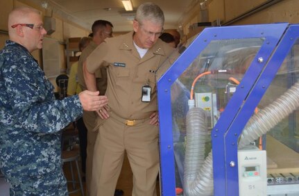 Senior Chief Machinery Repairman Sean A. Boykin explains the functionality of a 3-D computer numerically controlled router to Vice Adm. Thomas Moore, Naval Sea Systems commander inside the Southeast Regional Maintenance Center's Fabrication Laboratory. Boykin briefed senior DoD officials and visitors on the Fab Lab's additive manufacturing capability at the Department of the Navy's 2017 3D Print-a-Thon expo at the Pentagon, March 15. His team routinely applies the technology to solve maintenance problems by 3D printing components and saving time, money and resources in the process.  