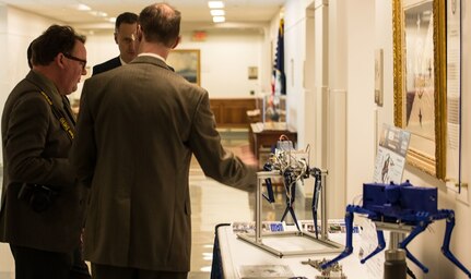 Members from the Meso-scale Robotic Locomotion Initiative (MeRLln) demonstrate the uses of a quadruped robot at the pentagon during a 3D Print-a-Thon. The reality of 3D Printing - also known as additive manufacturing - is expanding across the Navy's science and engineering community. U.S. Navy photo by Mass Communication Specialist 3rd Class Jason Meyer (Released)