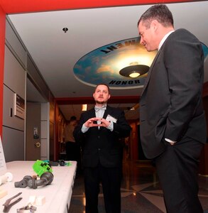 Steven Peterson, left, lab manager for the Technology and Innovation Lab, Mid-Atlantic Regional Maintenance Center (MARMC), Norfolk, Va., discusses innovative 3D printing solutions to everyday military operations during the Department of the Navy's 2017 3D Print-a-Thon expo at the Pentagon. Twenty DoN organizations - including scientists and engineers from the Naval Research and Development Establishment, maintenance operations, and Marines and Sailors from multiple commands - presented items produced through the use of Additive Manufacturing technology. Naval Surface Warfare Center Dahlgren Division coordinated the event, sponsored by the deputy assistant secretary of the Navy for research, development, test and evaluation. (U.S. Navy photo by Mass Communication Specialist 2nd Class Alex L. Smedegard/Released)