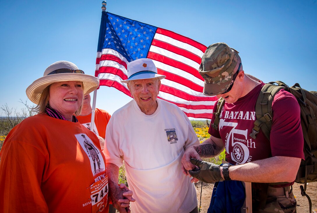Army Spc. Michael Cole, right, checks retired Army Col. Ben Skardon vital signs at the eight-mile mark during the Bataan Memorial Death March at White Sands Missile Range, N.M., March 19, 2017. Cole is a medic. Army photo by Staff Sgt. Ken Scar