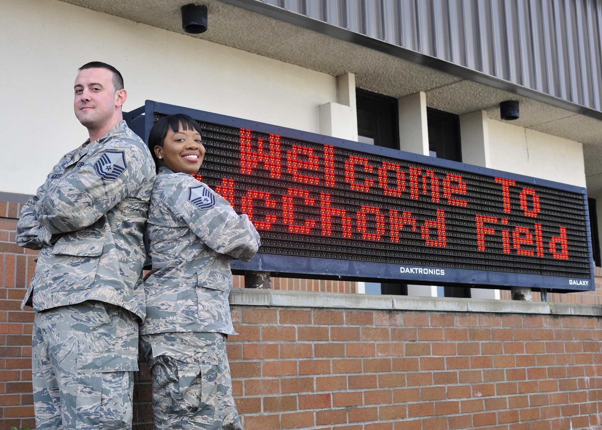 Master Sgt. Theodore (T.J.) McKee, 62nd Aerial Port Squadron passenger service operations NCOIC, and wife, Master Sgt. Tiffany McKee, 627th Logistics Readiness Squadron logistics plans superintendent, pose for a photo on the McChord Field flightline at Joint Base Lewis-McChord, Wash., March 16, 2017. Separated by military orders for more than half of their 4-year marriage, the McKees reunited at JBLM in early 2016 and ended the year as Team McChord Annual Award winners in their respective categories of NCO and SNCO. (U.S. Air Force photo/Staff Sgt. Whitney Amstutz)