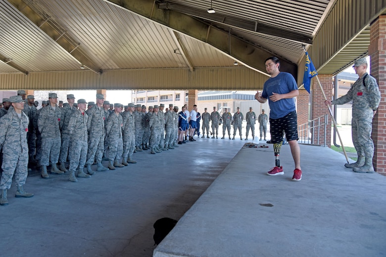 Austin Weed, 312th Training Squadron guest speaker, speaks to a group of students at one of the training group pavilions on Goodfellow Air Force Base, Texas, March 17, 2017. Weed lost his leg in a car crash and through his determination was able to get well enough to play basketball his senior year of high school. (U.S. Air Force photo by Staff Sgt. Joshua Edwards/Released)