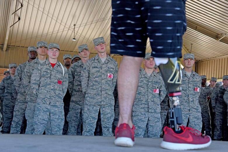 Austin Weed, 312th Training Squadron guest speaker, speaks to a group of students at one of the training group pavilions on Goodfellow Air Force Base, Texas, March 17, 2017. Weed, who lost his leg in a car crash, spoke about the importance of never giving up and friendship. (U.S. Air Force photo by Staff Sgt. Joshua Edwards/Released)