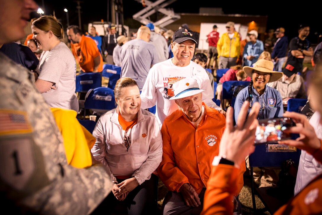 Retired Army Col. Ben Skardon, center right, and his assistant, Donna Burdette, pose for a photograph with fans before the opening ceremonies of the 28th annual Bataan Memorial Death March at White Sands Missile Range, N.M., March 19, 2017. Skardon is a survivor of the Bataan Death March and is the only survivor who walks in the memorial march. This is the tenth year in a row he has done so. Army photo by Staff Sgt. Ken Scar