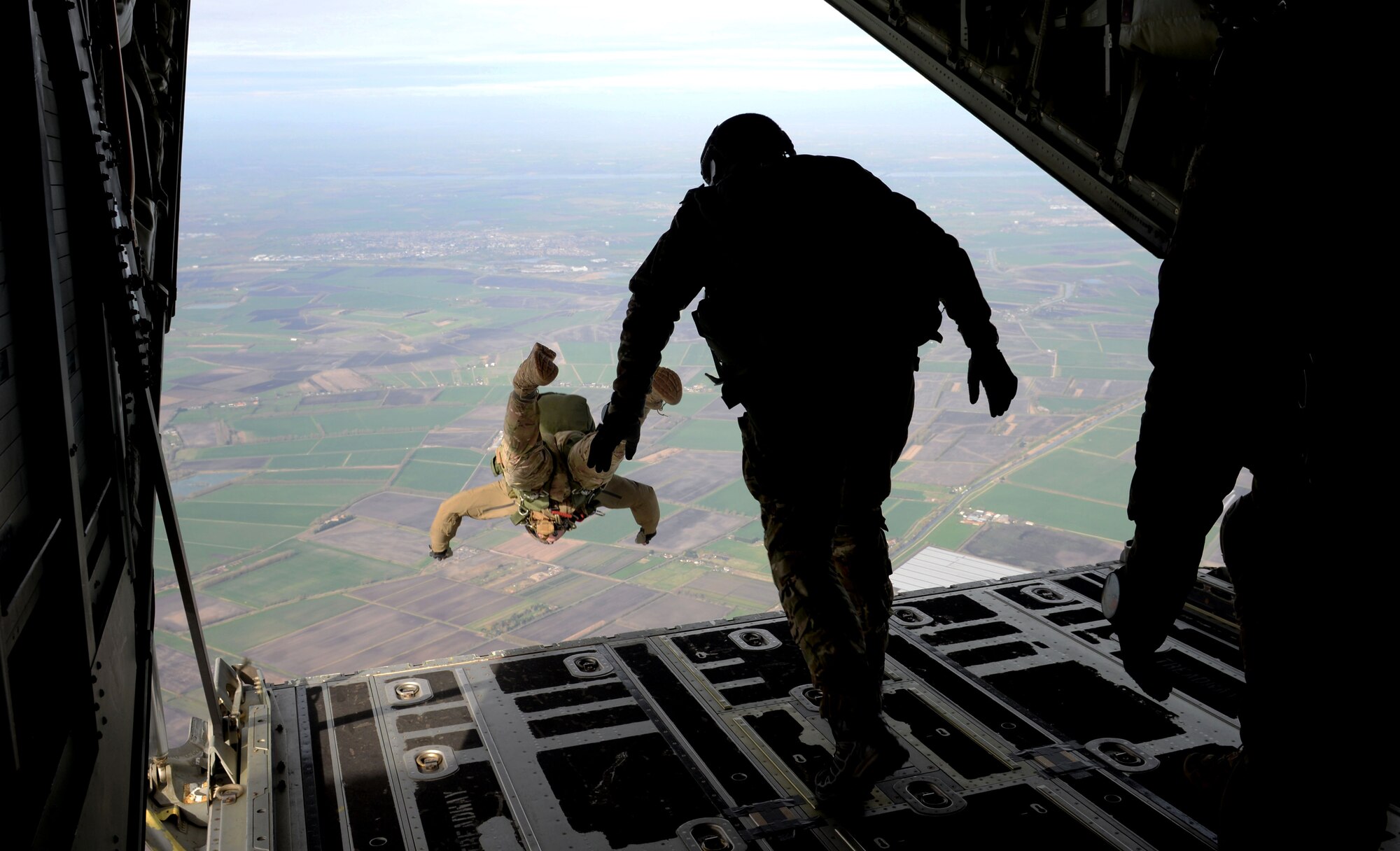 U.S. Air Force Air Commandos from the 321st Special Tactics Squadron perform a military free fall from an MC-130J Commando II March 17, 2017, over RAF Mildenhall, England. Air Commandos practice military free falls to stay prepared and highly trained for real-world situations that require the tactical maneuver. Friends and family of the Airmen were in attendance at the drop zone to support their air commandos. (U.S. Air Force photo by Staff Sgt. Kate Thornton)